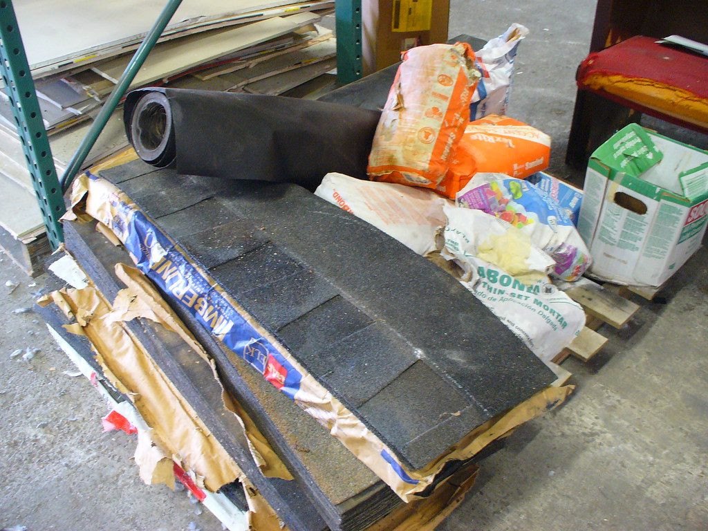 Typical repair: 60-mil white TPO flat roof over tapered ISO insulation, restoring positive drainage.